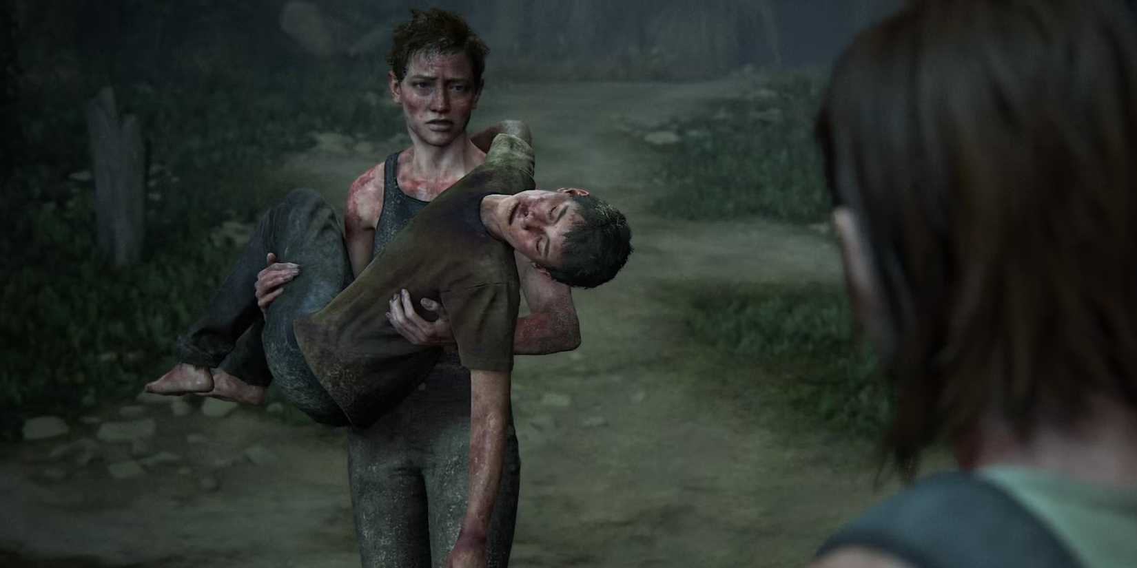 Abby carries Lev on the beach in The Last of Us Part II