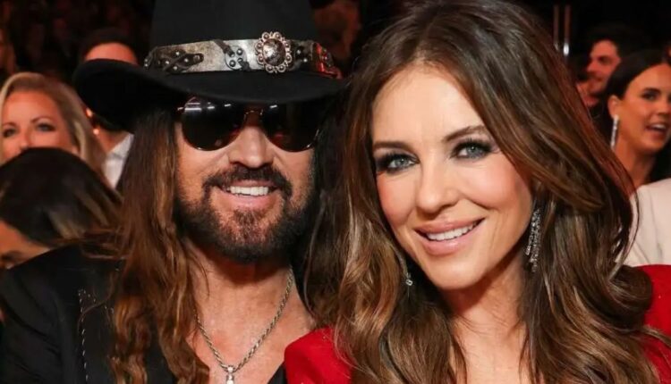 Elizabeth Hurley Stuns in Sheer Versace Minidress While Cuddling with Billy Ray Cyrus