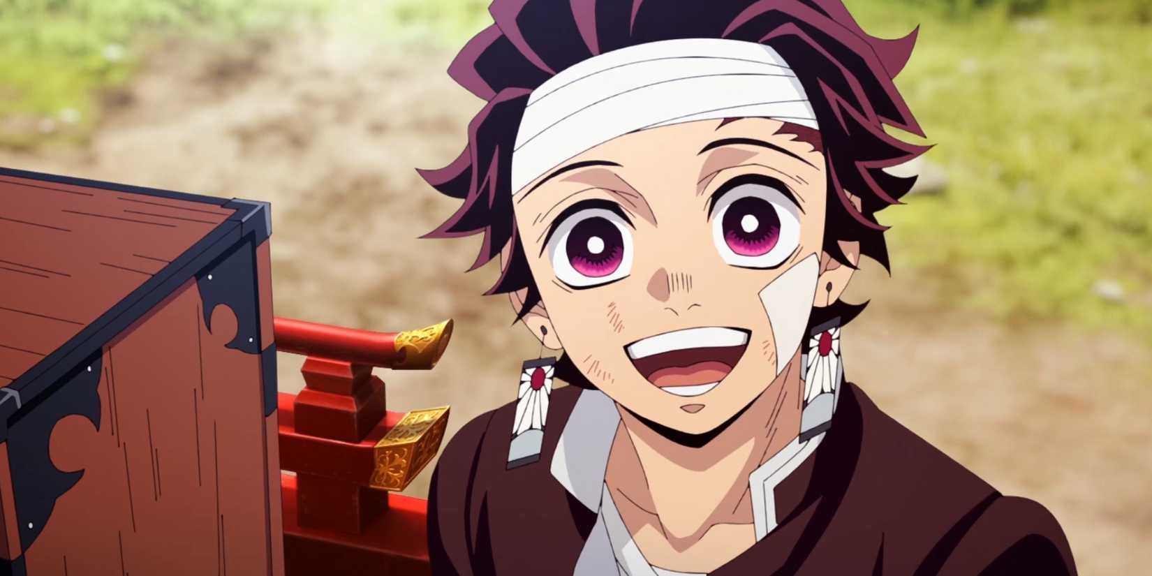 Tanjiro smiling next to Nezuko's box