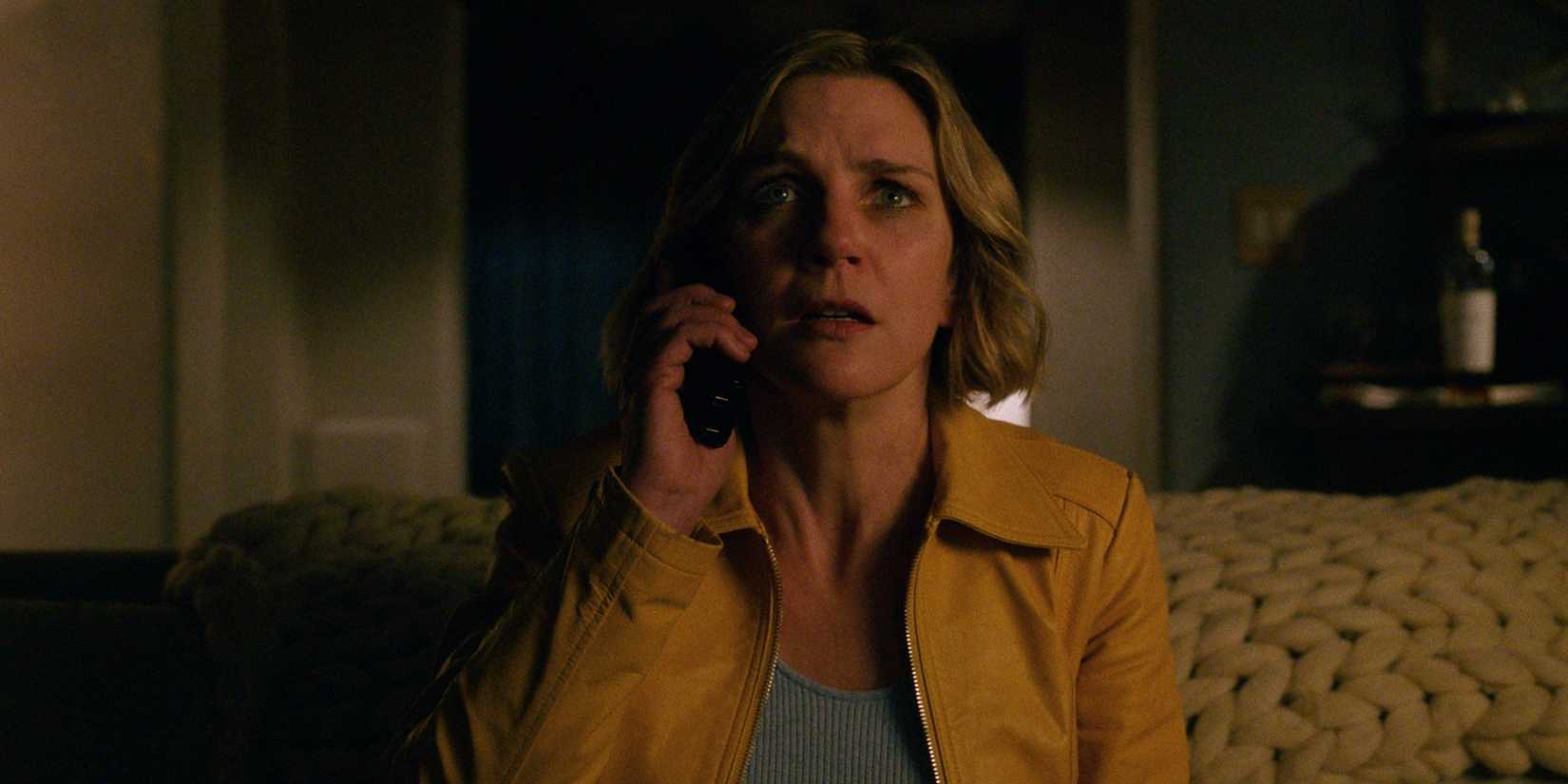 Rhea Seehorn looks up in fear while on the phone in Pluribus