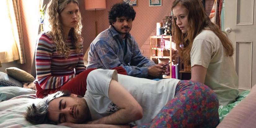 The cast gathered around a sleeping man in Extraordinary